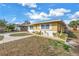 Well-maintained single-story home with a tidy lawn, fresh landscaping, and painted white brick base at 6537 8Th N Ave, St Petersburg, FL 33710
