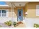 Inviting front entrance features a blue door with decorative glass and freshly painted white and yellow exterior at 6537 8Th N Ave, St Petersburg, FL 33710