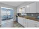 Bright kitchen with stainless steel appliances and granite counters open to the dining area at 6537 8Th N Ave, St Petersburg, FL 33710