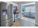 Open-concept kitchen with stainless steel appliances and view into the dining area at 6537 8Th N Ave, St Petersburg, FL 33710