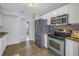 Modern kitchen with stainless steel appliances, granite countertops, and tile backsplash at 6537 8Th N Ave, St Petersburg, FL 33710