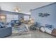 Bright living room with comfortable blue furniture, tile floors, and stylish decor at 6537 8Th N Ave, St Petersburg, FL 33710