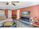 Living room boasting an electric fireplace, hardwood floors, coastal decor, and a TV for entertainment at 6537 8Th N Ave, St Petersburg, FL 33710