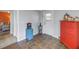 Functional mud room featuring tile flooring, access to the living room, and a bright red dresser at 6537 8Th N Ave, St Petersburg, FL 33710