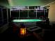 Inviting screened pool with a relaxing sitting area and landscape views at dusk at 6537 8Th N Ave, St Petersburg, FL 33710
