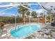 Inviting screened-in pool, surrounded by a stone patio, creates a private backyard oasis at 6537 8Th N Ave, St Petersburg, FL 33710