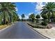 Well-manicured community entrance with mature trees and vibrant landscaping at 6618 Peach Tree Creek Rd, Bradenton, FL 34203