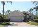 Charming single-story home boasts a well-manicured lawn, two-car garage, and beautiful landscaping at 6618 Peach Tree Creek Rd, Bradenton, FL 34203