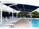 Community swimming pool with poolside lounge chairs and shade, perfect for relaxation at 6618 Peach Tree Creek Rd, Bradenton, FL 34203