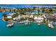 Desirable waterfront property with multiple boat lifts, a sparkling pool, and lush tropical landscaping provides a resort-like atmosphere at 7984 1St S Ave, St Petersburg, FL 33707