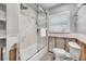 Modern bathroom with a shower, toilet, and sleek white fixtures at 7984 1St S Ave, St Petersburg, FL 33707