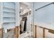 Bathroom featuring a shower, storage shelves, and a glass door at 7984 1St S Ave, St Petersburg, FL 33707