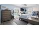 Bedroom featuring stylish decor, hardwood floors, access to the pool, and a large dresser at 7984 1St S Ave, St Petersburg, FL 33707