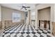 Cozy bedroom with a ceiling fan, checkerboard floors, and a closet for storage at 7984 1St S Ave, St Petersburg, FL 33707