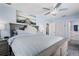 Comfortable bedroom with blue walls, striped bedding, ceiling fan, and access to an ensuite bathroom at 7984 1St S Ave, St Petersburg, FL 33707
