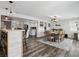 Open concept dining room adjacent to the kitchen, with wood floors and stylish furnishings at 7984 1St S Ave, St Petersburg, FL 33707
