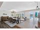 Stylish dining room with water views featuring a long wood table and modern light fixture at 7984 1St S Ave, St Petersburg, FL 33707