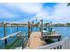 View of a private boat dock with boat lift and seating at 7984 1St S Ave, St Petersburg, FL 33707