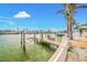 Waterfront dock with boat lift on a sunny day, offering direct access to the water at 7984 1St S Ave, St Petersburg, FL 33707