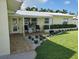 Charming front porch with seating, complemented by flowering shrubs and manicured landscaping at 7984 1St S Ave, St Petersburg, FL 33707