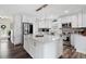 Bright kitchen with shaker cabinets, stainless steel appliances, island with white countertop and mosaic backsplash at 7984 1St S Ave, St Petersburg, FL 33707