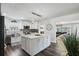 Bright kitchen with shaker cabinets, stainless steel appliances, island with white countertop at 7984 1St S Ave, St Petersburg, FL 33707