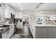 Bright kitchen with shaker cabinets, stainless steel appliances, dark floors, breakfast bar, and water view at 7984 1St S Ave, St Petersburg, FL 33707