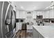 Bright kitchen with shaker cabinets, stainless steel appliances, large sink, and eat-in breakfast bar at 7984 1St S Ave, St Petersburg, FL 33707