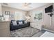 Inviting living room with a comfortable blue couch, area rug and bright windows at 7984 1St S Ave, St Petersburg, FL 33707