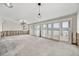 Spacious living room featuring sliding glass doors and modern pendant lighting at 7984 1St S Ave, St Petersburg, FL 33707