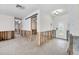 Spacious living room featuring exposed framing, a decorative front door and bright lighting at 7984 1St S Ave, St Petersburg, FL 33707