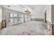 Bright, renovated open living space with waterfront views through large sliding glass doors and contemporary lighting at 7984 1St S Ave, St Petersburg, FL 33707
