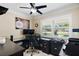 Office space with a large window, dark wood floors, and a ceiling fan at 7984 1St S Ave, St Petersburg, FL 33707