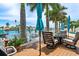 Outdoor seating area with palm trees and a waterfront view at 7984 1St S Ave, St Petersburg, FL 33707