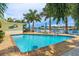 Gorgeous pool area with brick pavers, tropical landscaping, and waterfront views provides an idyllic outdoor space at 7984 1St S Ave, St Petersburg, FL 33707