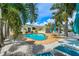 Backyard pool with outdoor seating and palm trees at 7984 1St S Ave, St Petersburg, FL 33707