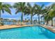 Inviting pool with pristine blue water, complemented by comfortable seating and stunning waterfront scenery at 7984 1St S Ave, St Petersburg, FL 33707