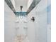 Shower featuring white tile with accent colors and a handheld shower head at 7984 1St S Ave, St Petersburg, FL 33707