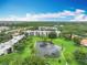 An aerial view of the condo community shows lush landscaping, a pond with fountain, and well-maintained buildings at 8174 Terrace Garden N Dr # 307, St Petersburg, FL 33709