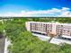 Bird's-eye view of a multi-story residential building surrounded by lush greenery and covered parking at 8174 Terrace Garden N Dr # 307, St Petersburg, FL 33709