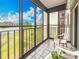 The screened-in balcony offers a peaceful view of a green lawn and nearby buildings at 8174 Terrace Garden N Dr # 307, St Petersburg, FL 33709