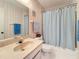 Bathroom with a sink, a toilet, and a bathtub with a light blue curtain covering the shower at 8174 Terrace Garden N Dr # 307, St Petersburg, FL 33709