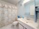Bathroom featuring a vanity, shower with curtain, mirror, toilet and tile flooring at 8174 Terrace Garden N Dr # 307, St Petersburg, FL 33709
