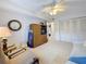 Neutral bedroom with a ceiling fan, a TV in an armoire, and ample storage space in the built-in closet at 8174 Terrace Garden N Dr # 307, St Petersburg, FL 33709