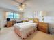 Bright bedroom features a ceiling fan, writing desk and chair, along with neutral carpet at 8174 Terrace Garden N Dr # 307, St Petersburg, FL 33709
