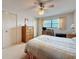 Bedroom features a ceiling fan, writing desk and chair, large dresser and closet at 8174 Terrace Garden N Dr # 307, St Petersburg, FL 33709