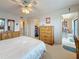 Bedroom with carpet, ceiling fan, view into dining area, large dresser and closet at 8174 Terrace Garden N Dr # 307, St Petersburg, FL 33709