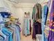 Walk-in closet featuring wire shelving, clothing racks, storage boxes and carpet at 8174 Terrace Garden N Dr # 307, St Petersburg, FL 33709