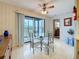 Eat-in kitchen dining area with a glass table, a ceiling fan, and access to the screened-in balcony at 8174 Terrace Garden N Dr # 307, St Petersburg, FL 33709