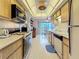 Galley kitchen features wood cabinets, smooth countertops, and an eat-in area with bright, natural light at 8174 Terrace Garden N Dr # 307, St Petersburg, FL 33709